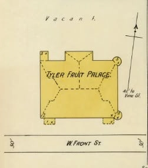 Detail of the 1898 Sanborn fire insurance map of Tyler, Texas: a yellow building footprint labeled Tyler Fruit Palace with round towers at its corners, fronting W. Front St., with an arrow toward Vine St.