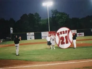 Red Murff Night at Mike Carter Field, August 2, 2001: a giant baseball reading Murff 21 on the infield during the number retirement ceremony under the lights