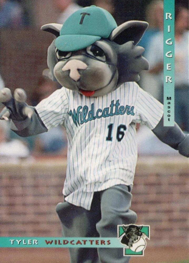 Tyler WildCatters baseball card of Rigger, the team mascot: a gray wildcat in a teal T cap and a white pinstriped number 16 Wildcatters jersey